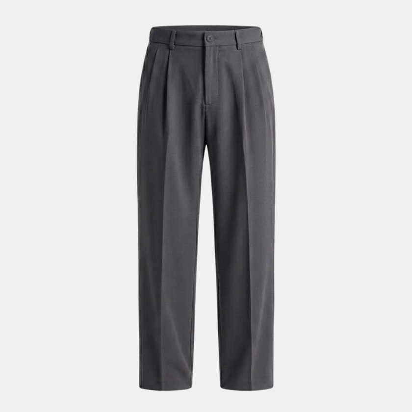 Men's pleated relaxed fit trousers by FJØRNA, shown in a neutral color, featuring a comfortable waistband and tailored design.