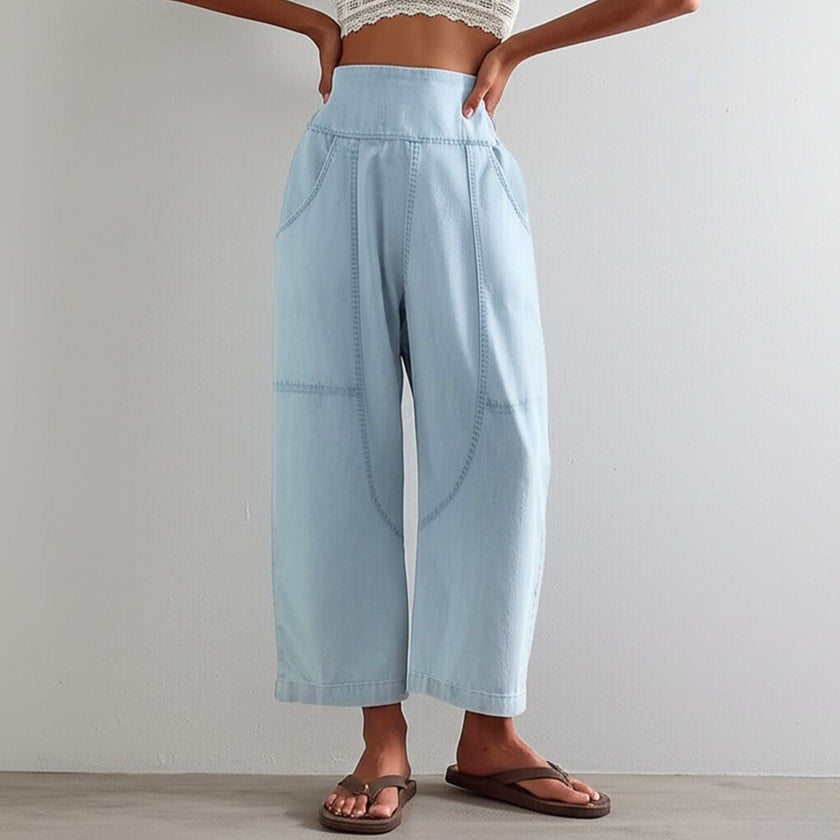 FJØRNA women's wide-leg denim trousers, casual pants with a relaxed fit, shown in a classic blue denim fabric.