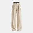 Women’s FJØRNA criss cross waist wide-leg trousers, showing the stylish high waist and flowing wide-leg design on a model.