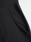 FJØRNA black sleeveless hooded jumpsuit with white vertical stripes, featuring a hood and fitted waist, casual and stylish.