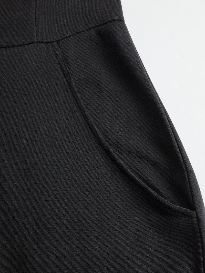 FJØRNA black sleeveless hooded jumpsuit with white vertical stripes, featuring a hood and fitted waist, casual and stylish.