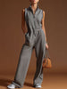 Dark grey FJØRNA cotton blend sleeveless zip-up jumpsuit displayed on a hanger, showing its fitted design and casual style.