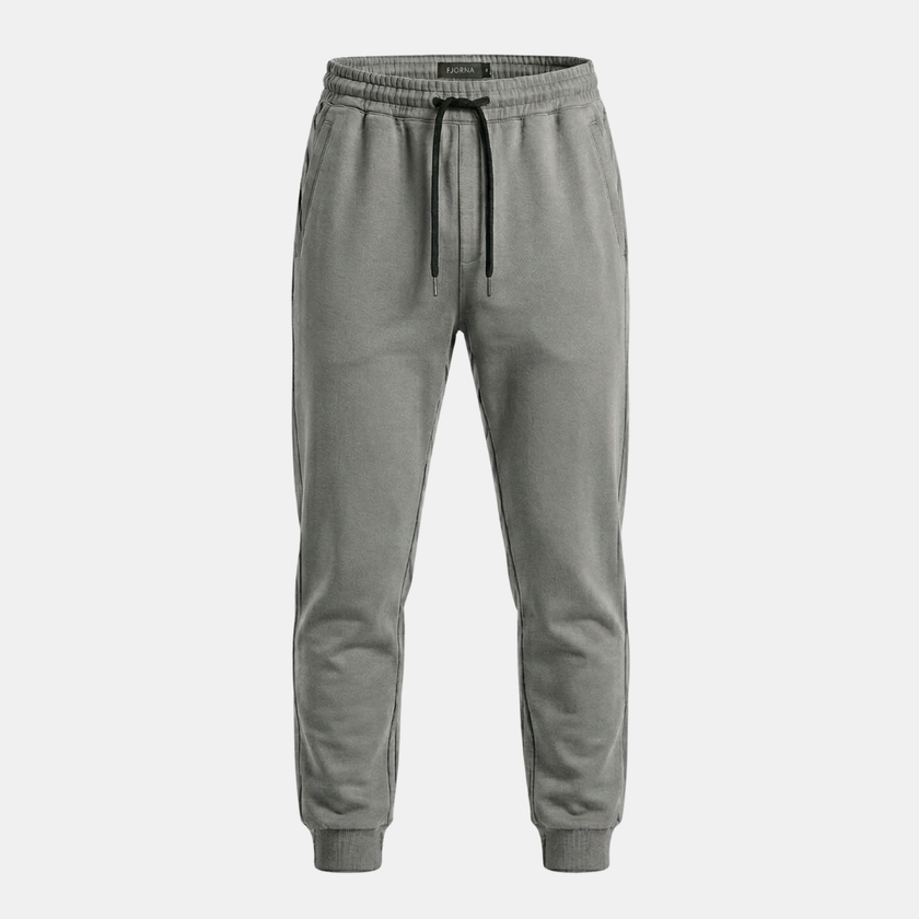 Men's relaxed fit jogger pants by FJØRNA with drawstring waist, made of comfortable fabric, shown in a natural standing pose.