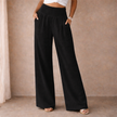 FJØRNA linen blend wide-leg women's trousers with elastic waistband, relaxed fit, and casual style, shown on a model.