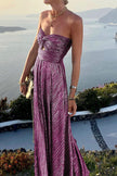 FJØRNA Celeste women's strapless A-line evening gown with pleated metallic fabric, elegant and flowing design for formal occasions.