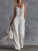White faux suede Western fringe V-neck jumpsuit by FJØRNA featuring fringe details and a V-neck design.