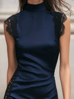 Navy satin mini dress by FJØRNA featuring black lace trim, fitted silhouette, and elegant sleeveless design.