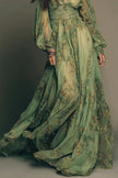 FJØRNA botanical print V-neck long-sleeved fitted waist casual maxi dress displayed with floral pattern and flowing silhouette.