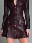 FJØRNA Retro stand V-neck eco-leather mini dress displayed on a hanger, showcasing its sleek silhouette and minimalist design.