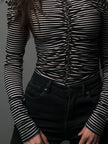 Black striped high neck cold-shoulder T-shirt by FJØRNA with ruched detailing and long sleeves, stylish and trendy for casual wear.