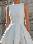 FJØRNA sleeveless structured pleated mini dress with a fitted bodice and flared skirt, displayed on a mannequin.