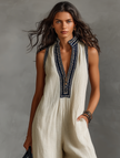 FJØRNA linen blend sleeveless jumpsuit for women with stand collar and embroidery detail, shown as stylish pants on model.