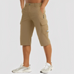 FJØRNA men's stretch cargo pants showing a relaxed fit, multiple pockets, and durable fabric in a neutral color.