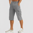 FJØRNA men's stretch cargo pants, featuring multiple pockets and a relaxed fit, displayed on a model.