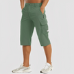 FJØRNA men's stretch cargo pants in durable fabric, featuring multiple pockets and a relaxed fit for casual wear.
