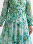 FJØRNA floral long sleeve maxi dress for women, elegant and flowing with a vibrant floral pattern and fitted waist.