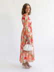 FJØRNA floral long sleeve maxi dress for women, elegant design with a flowing silhouette and vibrant floral pattern.