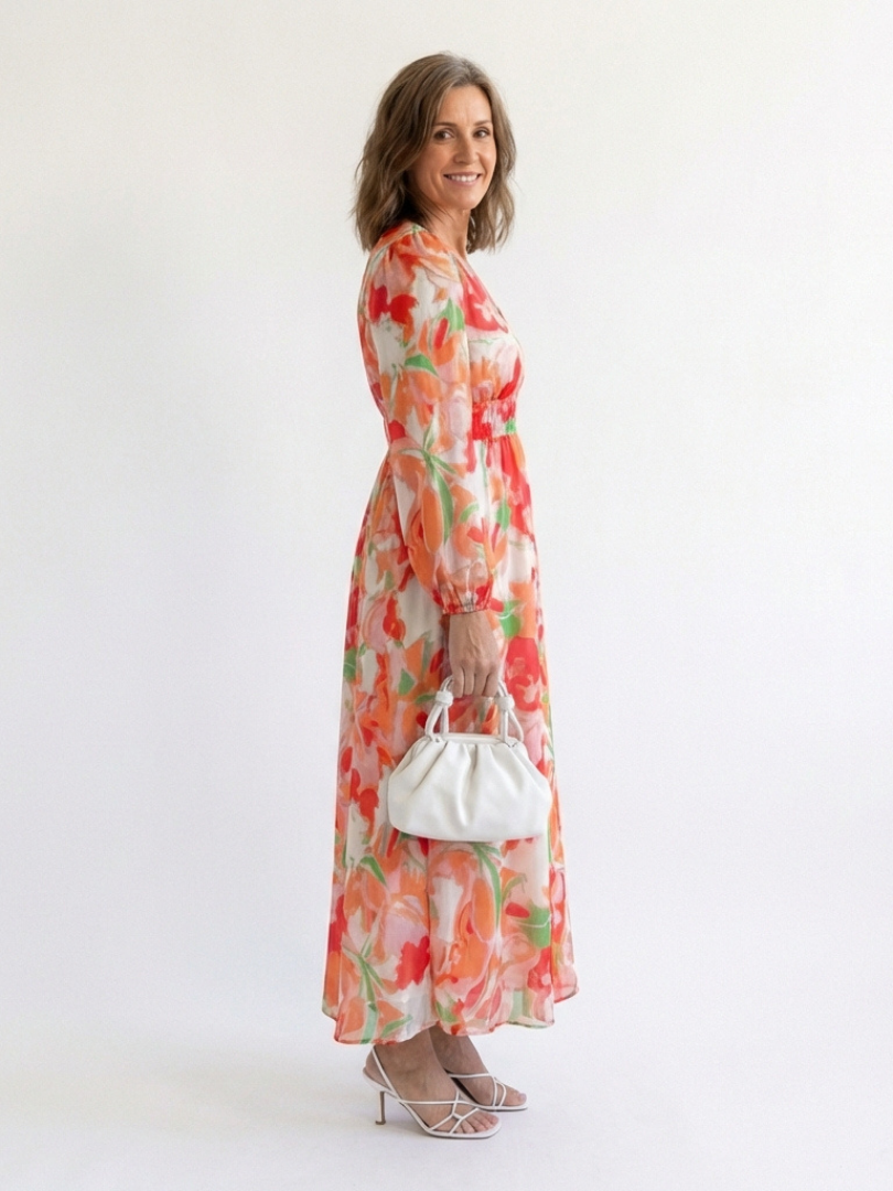 FJØRNA floral long sleeve maxi dress for women, elegant design with a flowing silhouette and vibrant floral pattern.