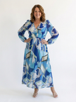 FJØRNA elegant floral maxi dress for women with long sleeves, flowing fabric, and a sophisticated design for special occasions.