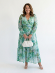 FJØRNA elegant floral maxi dress for women with long sleeves, flowing fabric and a stylish silhouette.