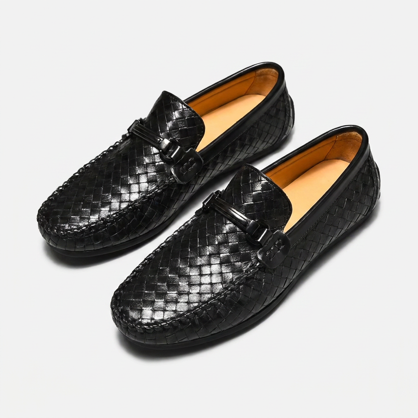 FJØRNA men's woven black leather slip-on driving loafers displayed at an angle, showcasing the textured woven design and sleek style.