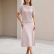 FJØRNA apricot flowing midi dress and cropped open-knit mesh top 2-piece set displayed on a model.