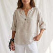 Apricot women's summer blouse by FJØRNA with V-neck, linen fabric, and button front, stylish top for warm weather.