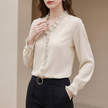 Apricot women's summer blouse by FJØRNA with V-neck and puff sleeves, made of lightweight chiffon fabric.
