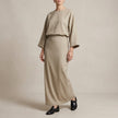 FJØRNA two-piece textured woven skirt suit in apricot with draped high-waist silhouette, featuring a stylish and elegant design.
