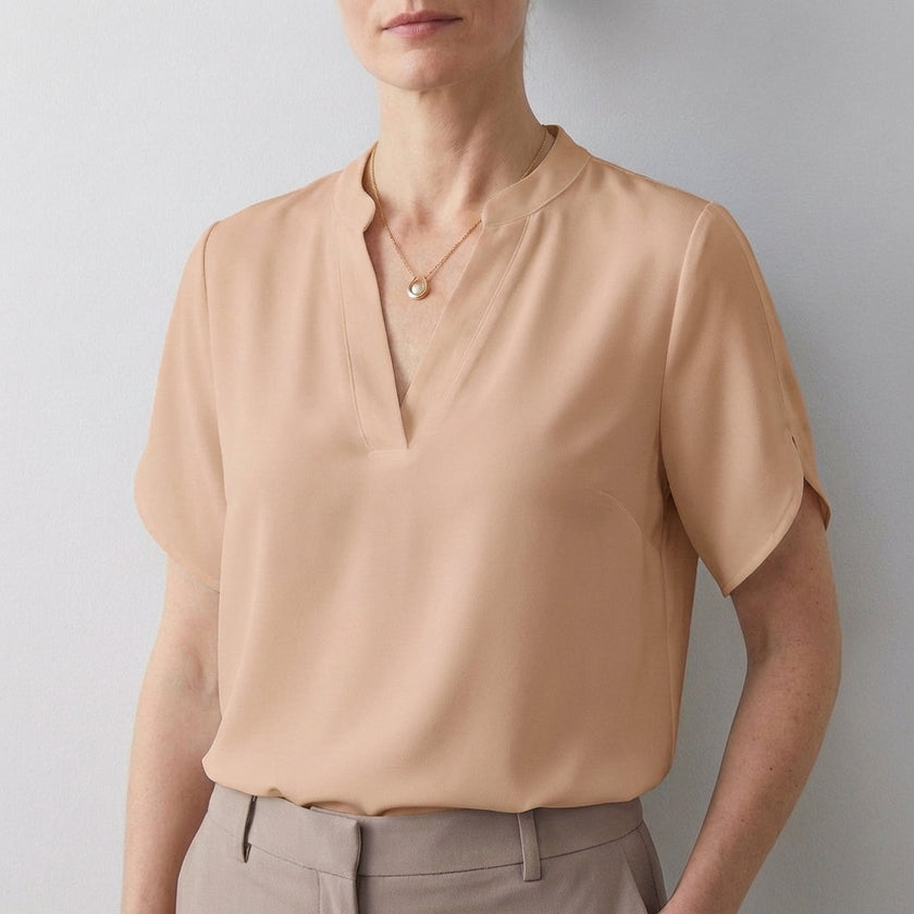 Apricot V-neck short sleeve flowy summer blouse for women by FJØRNA, featuring a relaxed fit and lightweight fabric.