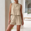 FJØRNA relaxed textured apricot two-piece set with pleated shorts and button-front tank top on a model.
