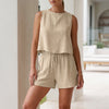 FJØRNA relaxed textured apricot two-piece set with pleated shorts and button-front tank top on a model.