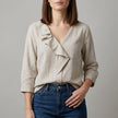 Apricot FJØRNA women's summer blouse with v-neck and ruffle denim details, stylish top for warm weather wear
