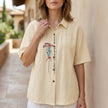 FJØRNA women's floral summer blouse in apricot denim with short sleeves, lightweight and stylish for warm weather.