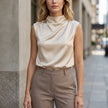 Apricot high neck sleeveless satin blouse for women by FJØRNA, stylish summer top with elegant satin fabric.