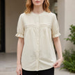 Apricot FJØRNA summer women's blouse with puff sleeves, denim fabric, and button front, stylish and lightweight top for warm weather.