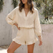 FJØRNA apricot relaxed two-piece set with ruffle shorts and tie-front blouse, casual summer outfit on a model.