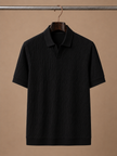 Men's luxury knit polo shirt by FJØRNA, soft textured breathable summer polo for men, shown in a stylish close-up image.