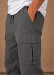 Men's cargo pants by FJØRNA featuring a relaxed fit, utility pockets, and casual style, suitable for everyday wear.