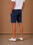 Men's FJØRNA chino shorts in cotton blend, tailored fit, smart casual style, shown on a model.