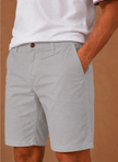 Men's FJØRNA chino shorts in cotton blend, tailored fit, smart casual style, shown in a natural stance with front pockets and rolled hems.