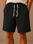 Men's linen drawstring shorts by FJØRNA featuring a relaxed fit with white stripes and a casual, breathable design.