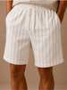 Men's linen drawstring shorts by FJØRNA featuring a relaxed fit with white and striped pattern, casual and comfortable men's pants.