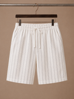 Men's linen drawstring shorts by FJØRNA featuring a relaxed fit and white striped pattern, casual men's pants for warm weather.