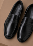 Men's leather penny loafers by FJØRNA, featuring classic smart casual style with sleek leather finish and comfortable slip-on design.