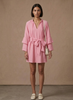 Women's FJØRNA ruffle hem mini dress with long sleeves and belted waist, featuring a feminine and stylish design.
