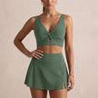 Army green women's summer bikini with V-neck and cut-out design from FJØRNA, showcasing the stylish swimwear on a model.