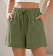 Army green women's linen summer shorts with pockets and drawstring, casual and breathable FJØRNA shorts for warm weather.