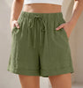 Army green women's linen summer shorts with pockets and drawstring, casual and breathable FJØRNA shorts for warm weather.