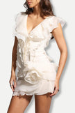 FJØRNA asymmetric ruffled mini dress for women, featuring a stylish design suitable for party or day wear, shown on a model.